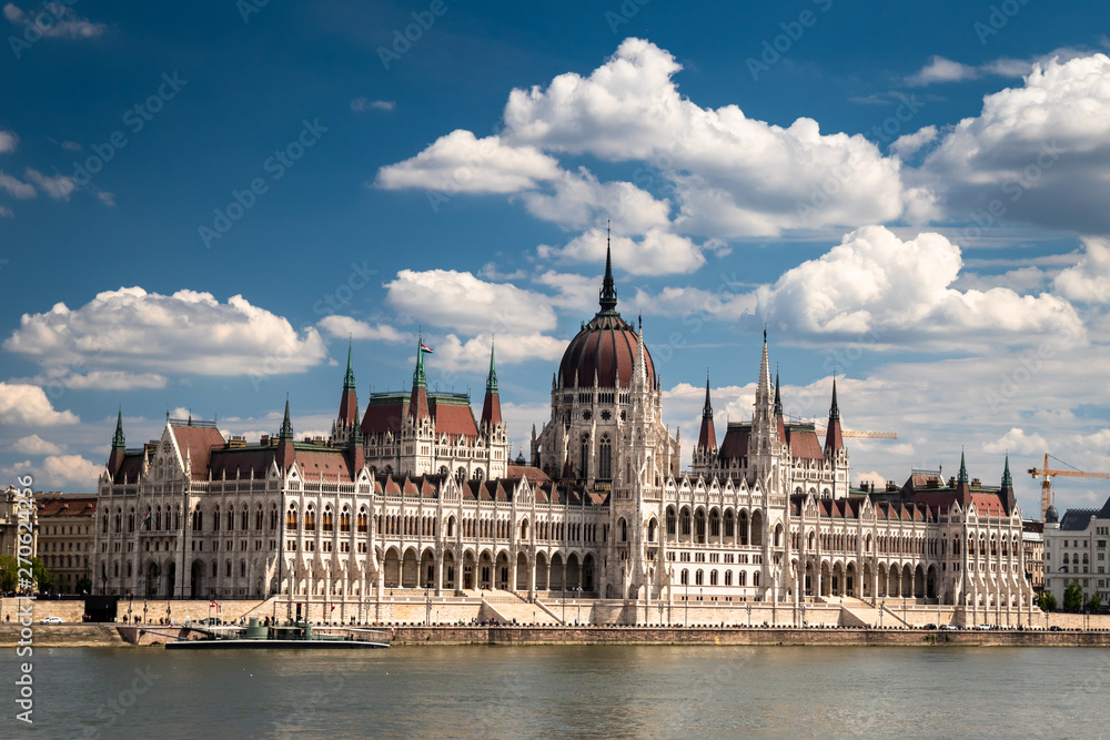 Obraz premium Building of the hungarian parliament in a Budapest, capital of Hungary, by the Danube river. One of the landmark of Budapest, and popular tourist destination.