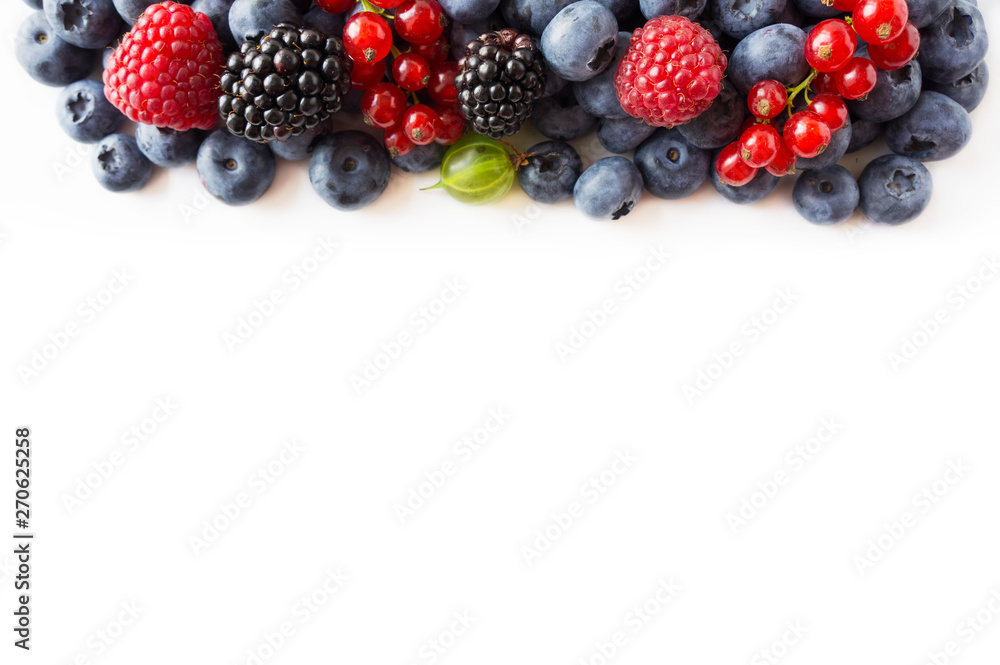 Mix berries on a white background. Ripe blueberries, red currants, backberries, gooseberries and raspberries on white background. Top view. Fruits and berries at border with copy space for text. Mix berries on a white background. Ripe blueberries, red currants, backberries, gooseberries and raspberries on white background. Top view. Fruits and berries at border with copy space for text.