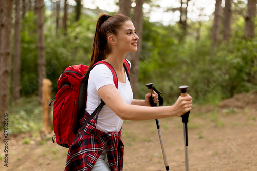Young woman hiking on fores...