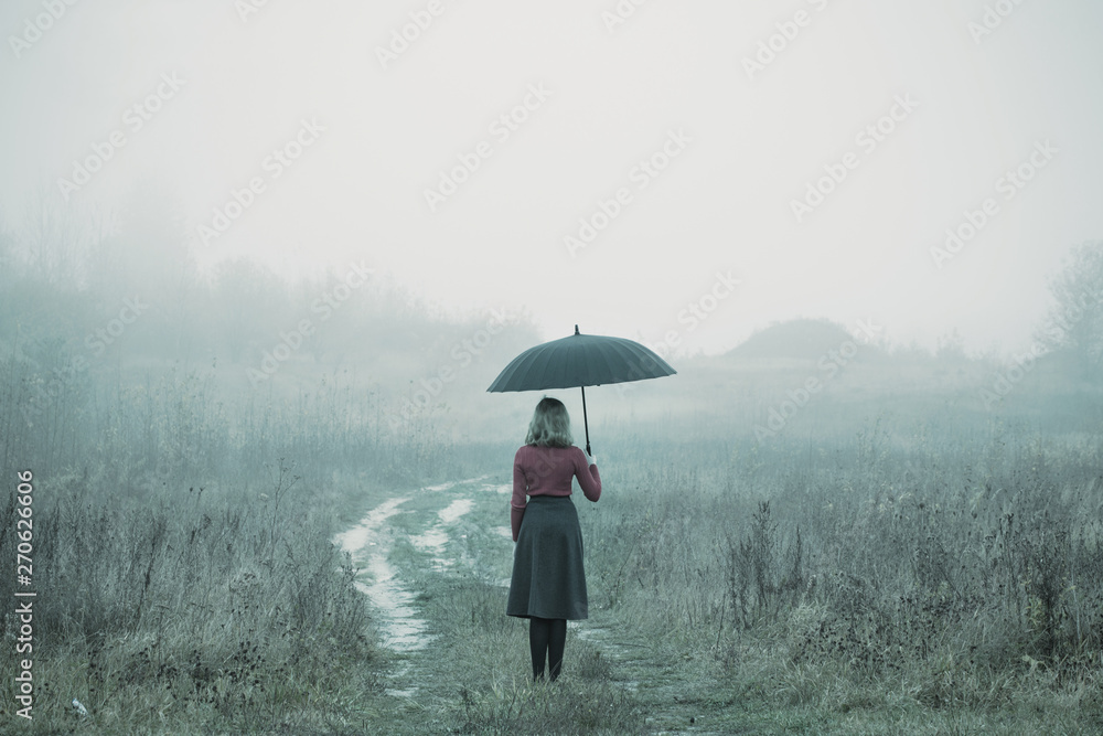 young girl with umbrella in autumn field - obrazy, fototapety, plakaty 