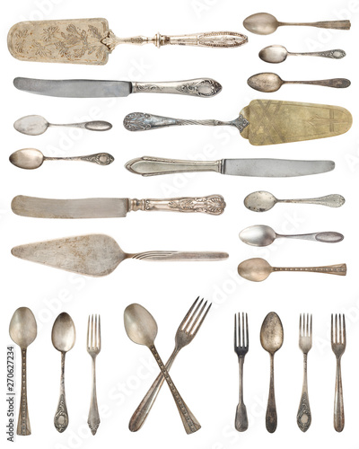Top view of beautiful vintage silver knifes, spoons and forks  isolated on white background. Silverware.