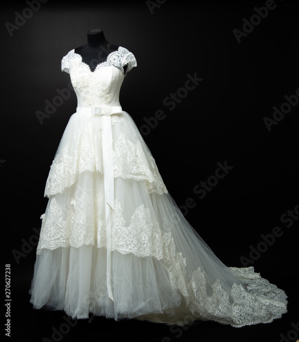 white wedding dress on black background in studio