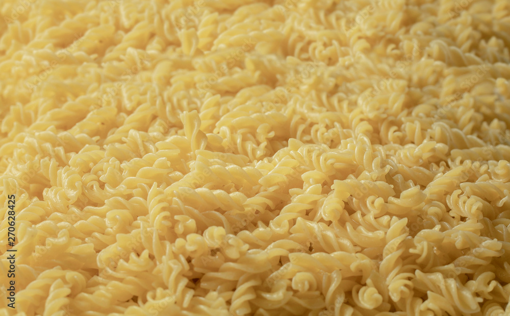 Boiled pasta forming a background Boiled pasta forming a background