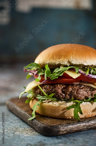Tasty hamburger with vegetables and rucola