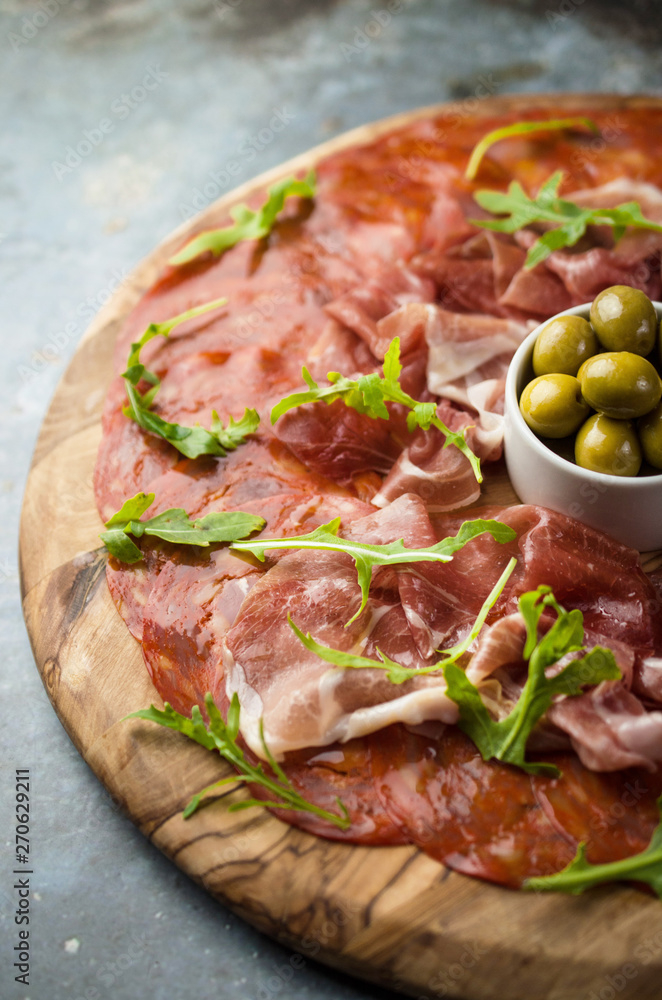 Traditional Spanish Serrano ham with olives