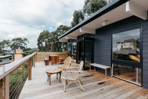A large deck with outdoor seating at a beach home