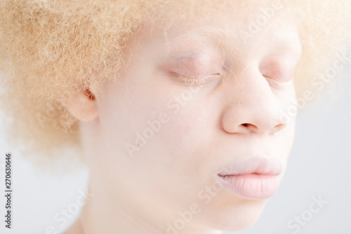 Portrait of albino girl with close eyes photo