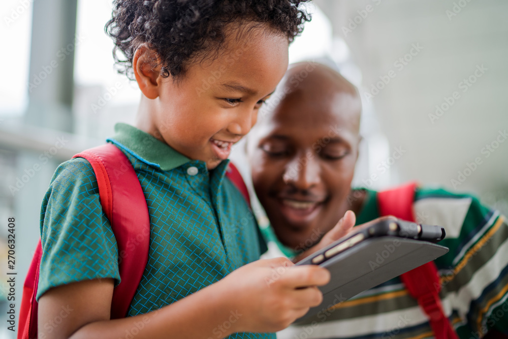Father and son looking at digital tablet Father and son looking at digital tablet