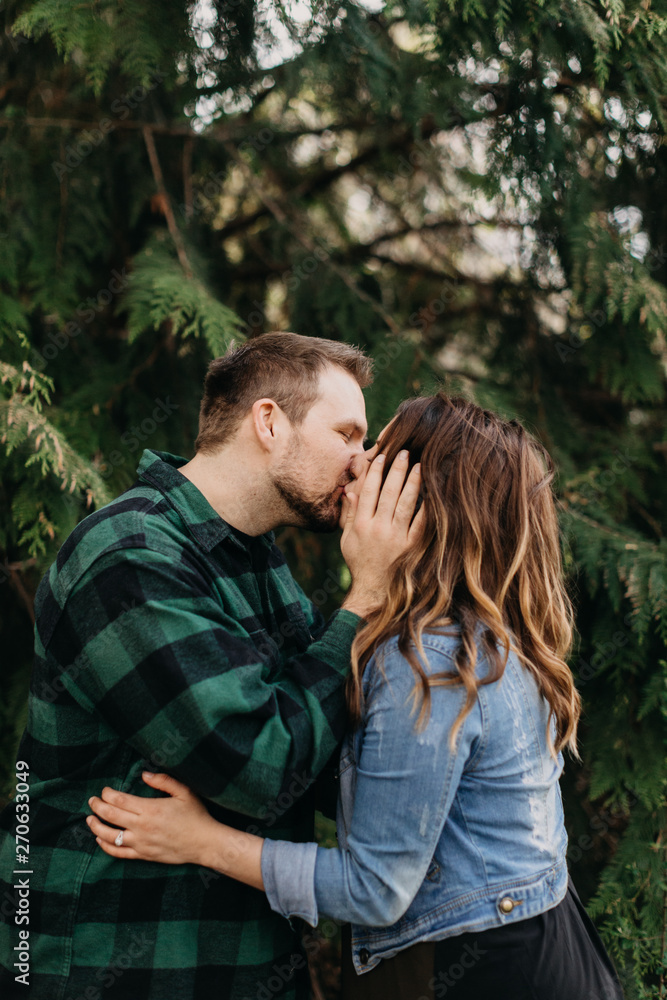 Beautiful Young Couple Kissing in Forest Beautiful Young Couple Kissing in Forest