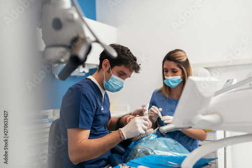 Dentist during a dental intervention. photo