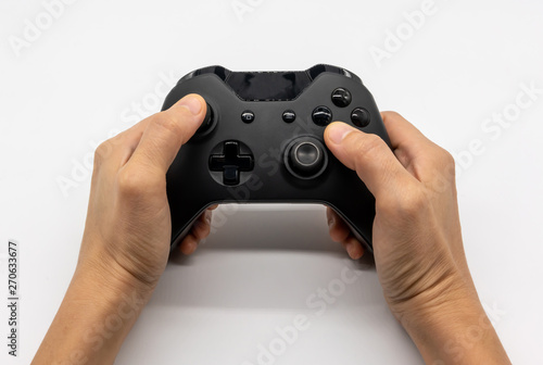 Video game console controller in gamer hands. Hand hold new joystick isolated on white