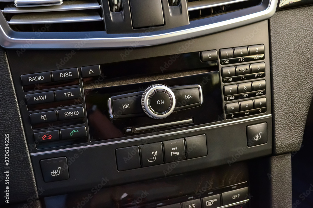 Control buttons for multimedia system, phone connected via bluetooth for talking on the speakerphone in the car on the black panel, heated seats and parking sensors.