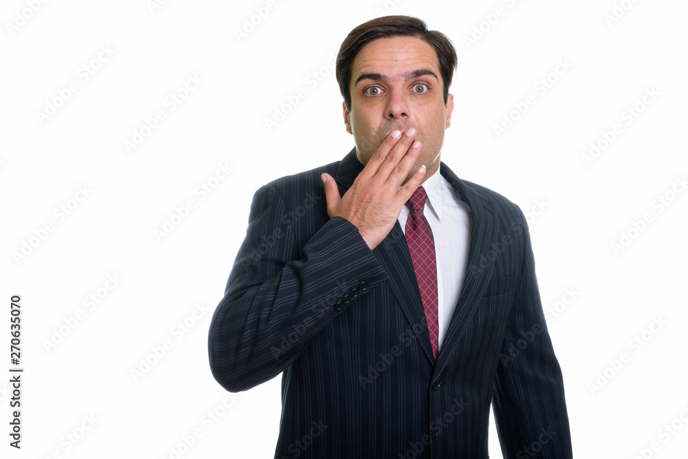 Studio shot of young Persian businessman looking shocked isolate Studio shot of young Persian businessman looking shocked isolate