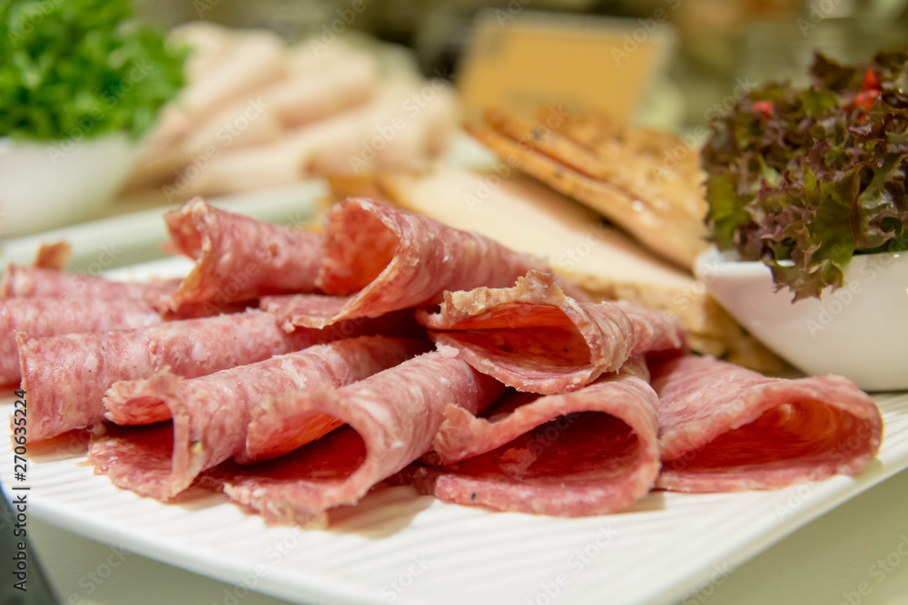 A delicious slice salami on plate for buffet