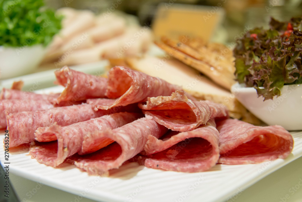 A delicious slice salami on plate for buffet A delicious slice salami on plate for buffet