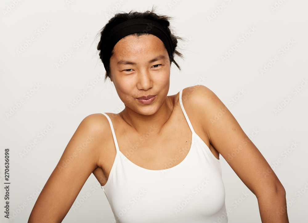 Young natural asian woman portrait applying moisturiser. Young natural asian woman portrait applying moisturiser.