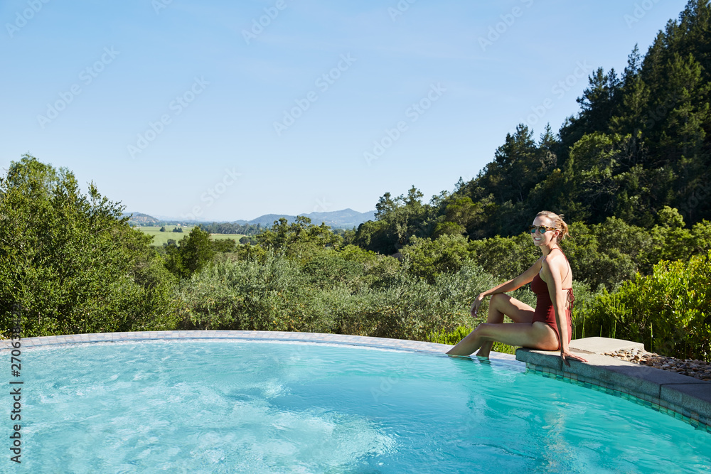 Mature woman relaxing and smiling at spa pool