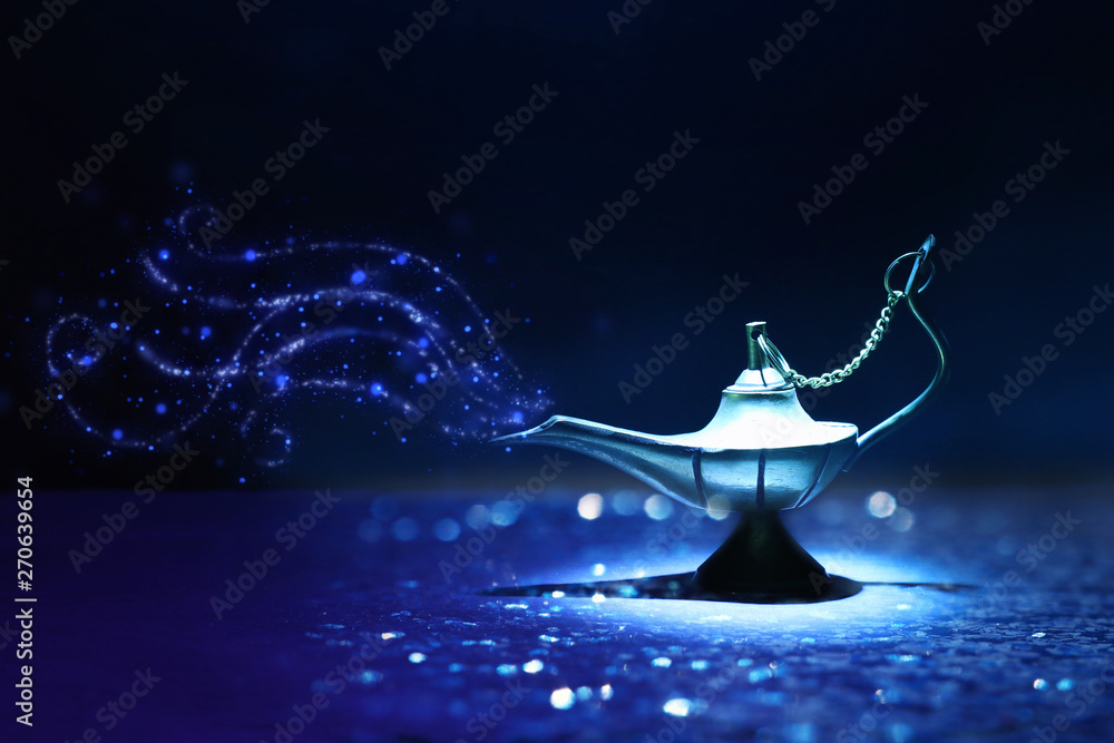 Image of magical mysterious aladdin lamp with glitter smoke. Dark