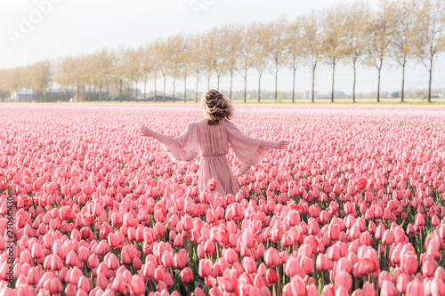 Young woman in a tulip field photo