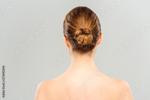 back view of naked woman standing isolated on grey