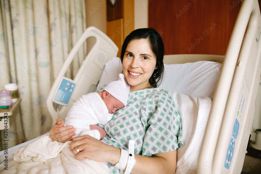 mom holds baby in hospital bed Stock Photo Adobe Stock