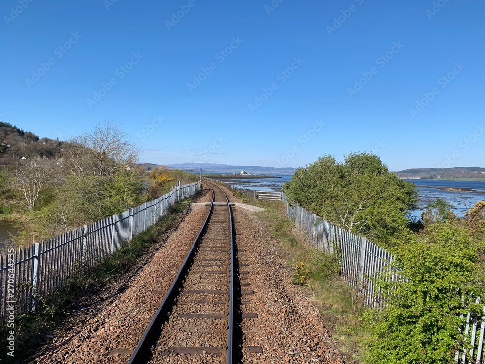 empty train tracks heading into the horizon in scotland
