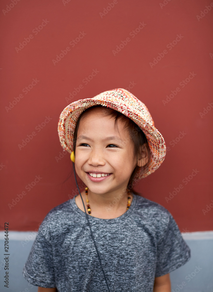 Pretty Asian little girl expression. Ancient architecture wall background Pretty Asian little girl expression. Ancient architecture wall background