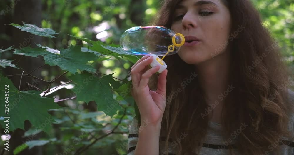 Girl blowing soap bubbles. Back to childhood concept. Girl blowing soap bubbles. Back to childhood concept.