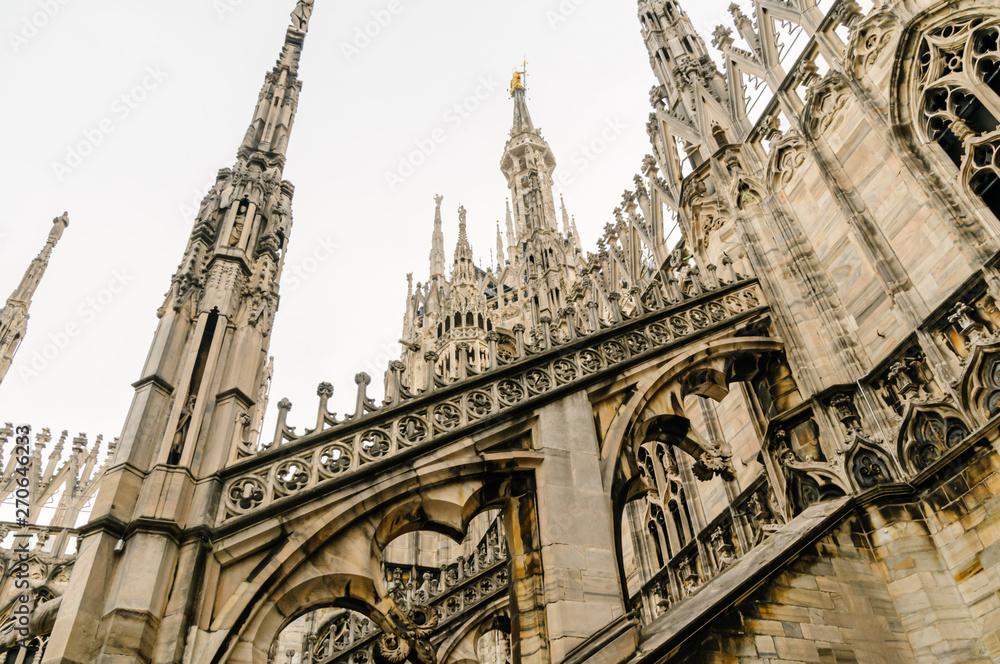 Flying buttress and ornately carved stonework on the roof of the Duomo di Milano (Milan Cathedral), Italy