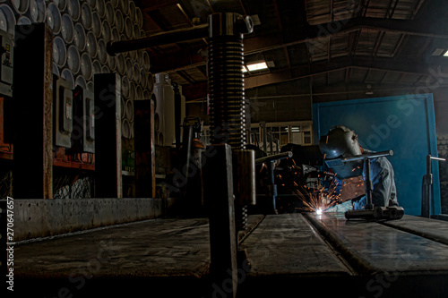 Welder welding in industry space