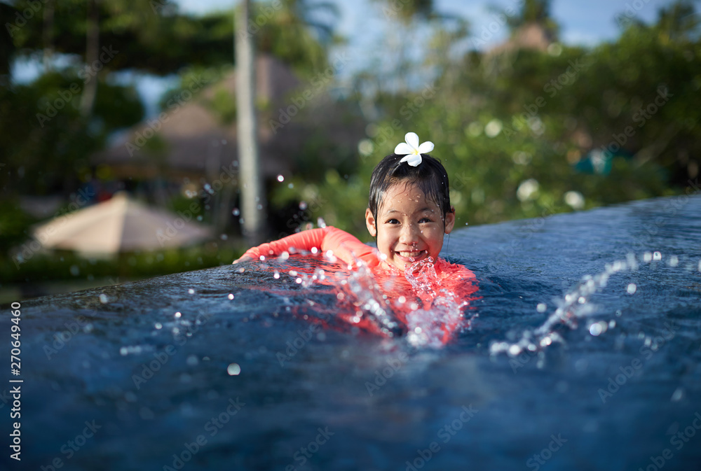 Cute asian little girl playing in the pool Stock Photo | Adobe Stock