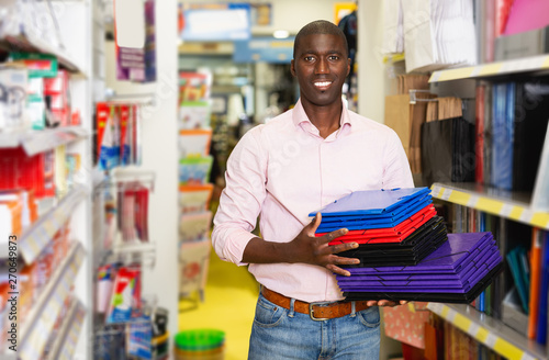 African american male customer looking documents folder