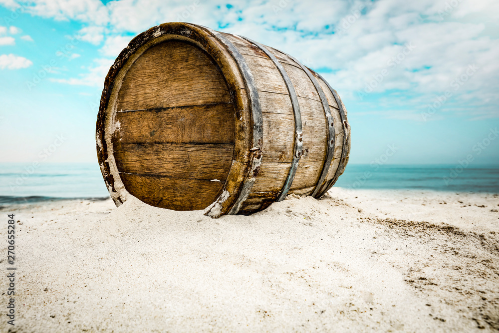 barrel on sand and beach background. Stock Photo Adobe Stock