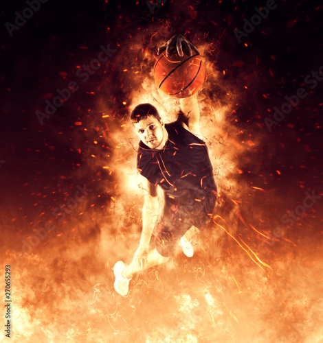 Man basketball player on flames background © Andrey Burmakin