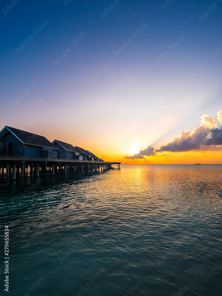Maldives, Ross Atoll, water bungalows at sunset Maldives, Ross Atoll, water bungalows at sunset