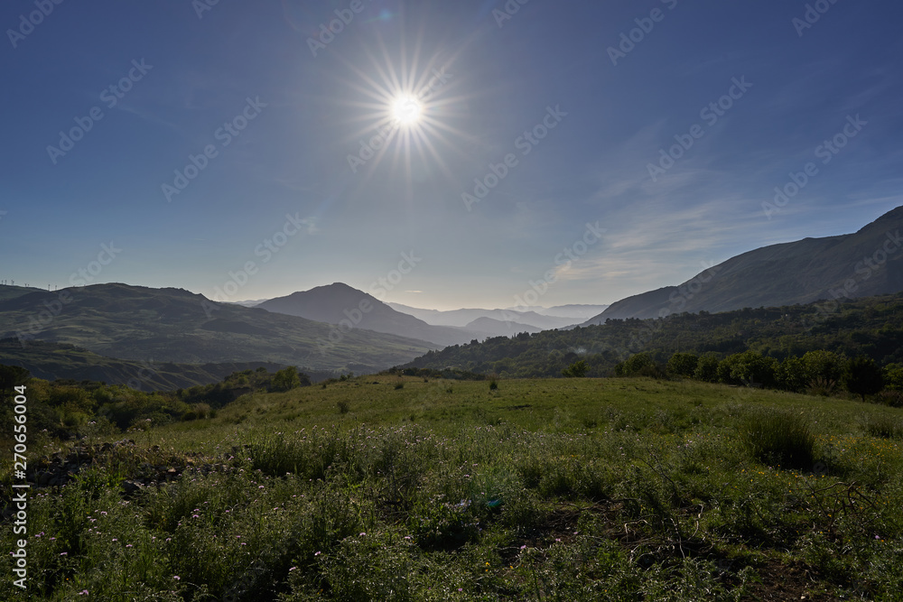 Landscape of mountains of Madonie in sunny evening. Madonie are one of principal mountain ranges on island of Sicily, located in southwestern Italy, Range is located within Palermo Province of Sicily.