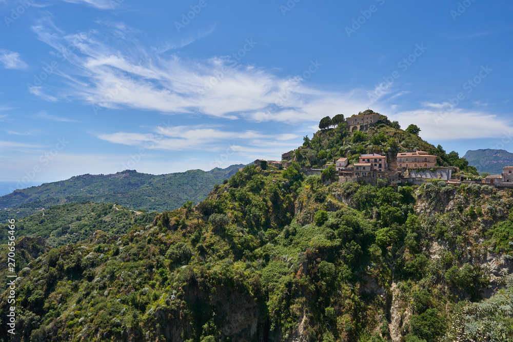 Landscape or cityscape picture of Italian town Savoca in Sicily. Beautiful historic town from middle ages, houses made from stone with terracotta roofs., placed on high mountains of sicilian coast.