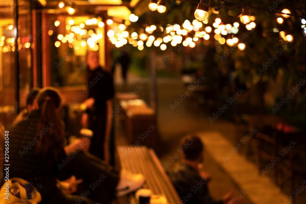 The atmosphere of a cozy relaxed mood, an evening meeting of young people in a coffee shop, blurred background