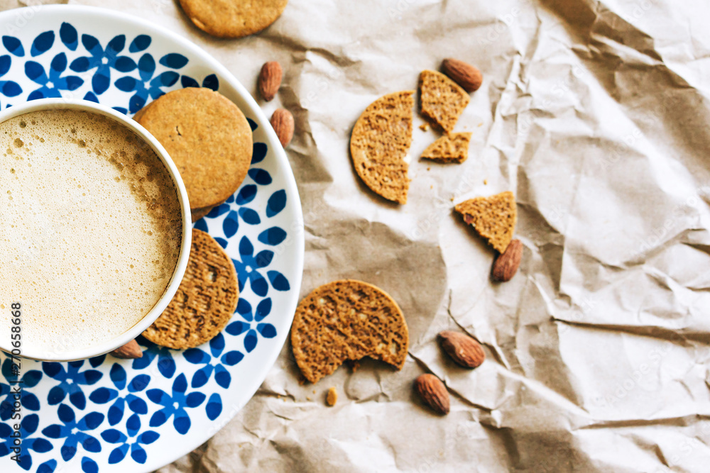 Top view of a cup of coffee and crispy crumbly biscuits, fletley healthy breakfast, trendy dishes and a simple background. Top view of a cup of coffee and crispy crumbly biscuits, fletley healthy breakfast, trendy dishes and a simple background.