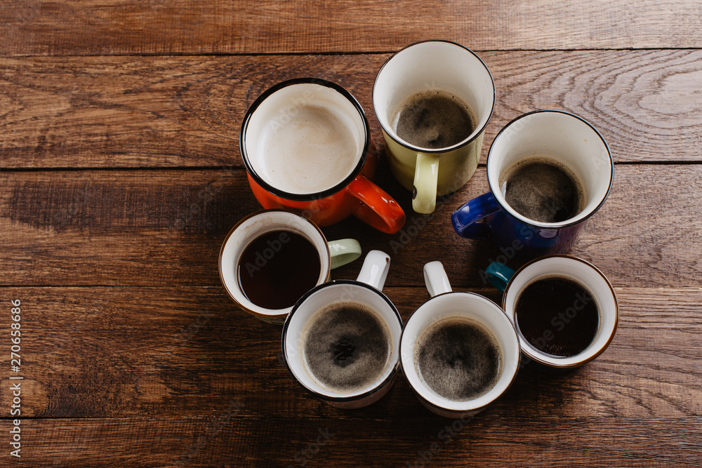various mugs of coffee, wooden table, top view various mugs of coffee, wooden table, top view