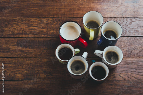 various mugs of coffee, wooden table, top view