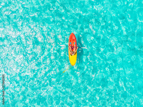 Kayak boat turquoise blue water sea, sunny day. Concept travel. Aerial top view photo