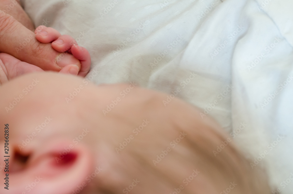 Hand of newborn baby holding male adults finger. Concept of help and family. Father holding hand. Hand of newborn baby holding male adults finger. Concept of help and family. Father holding hand.