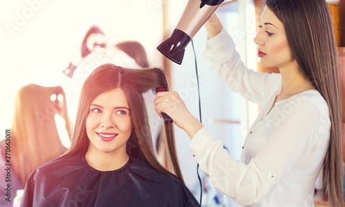 Fotografie Stylist blow drying hair of a client at the beauty salon hair blow stylist conte