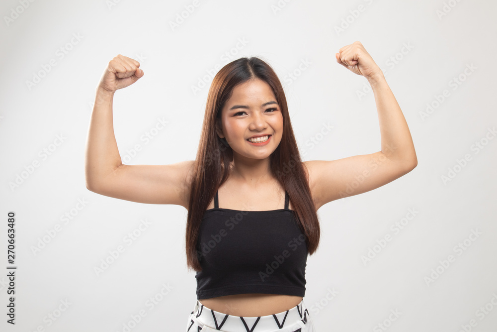 Beautiful young Asian woman flex bicep. Beautiful young Asian woman flex bicep.