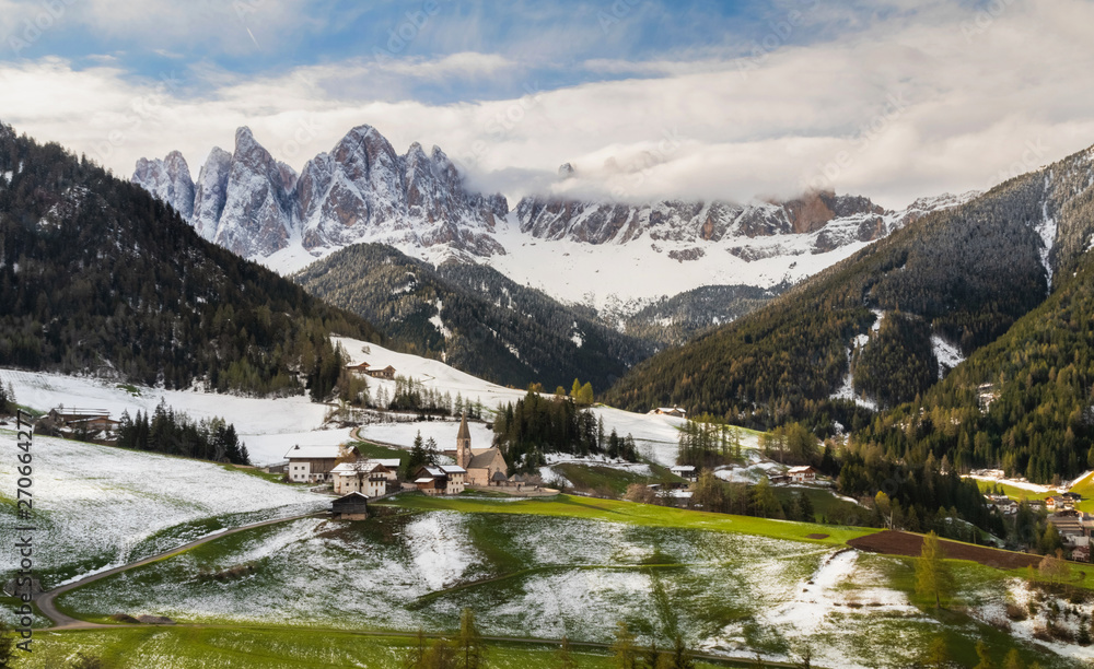 Snowy spring in Santa Maddalena (St Magdalena) village with magical Dolomites mountains in background , Val di Funes valley, Italy, Europe