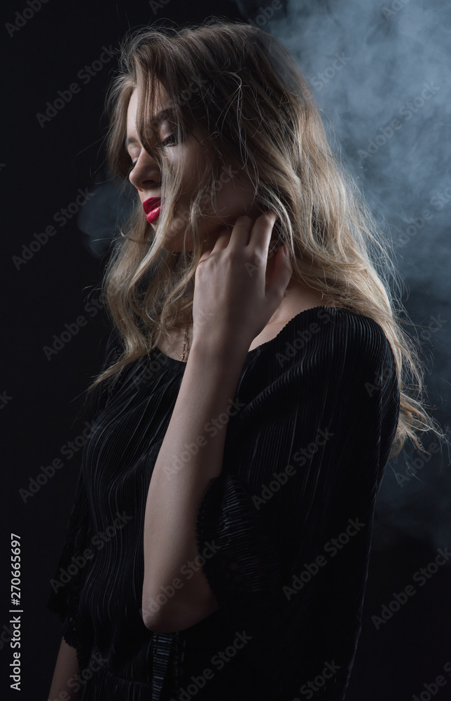 Beautiful ,young blonde with bright red lips and expressive eyes in a black jumpsuit. Beauty portrait of a girl. Emotional and bright appearance. Fashion portrait of a woman. Beautiful ,young blonde with bright red lips and expressive eyes in a black jumpsuit. Beauty portrait of a girl. Emotional and bright appearance. Fashion portrait of a woman.
