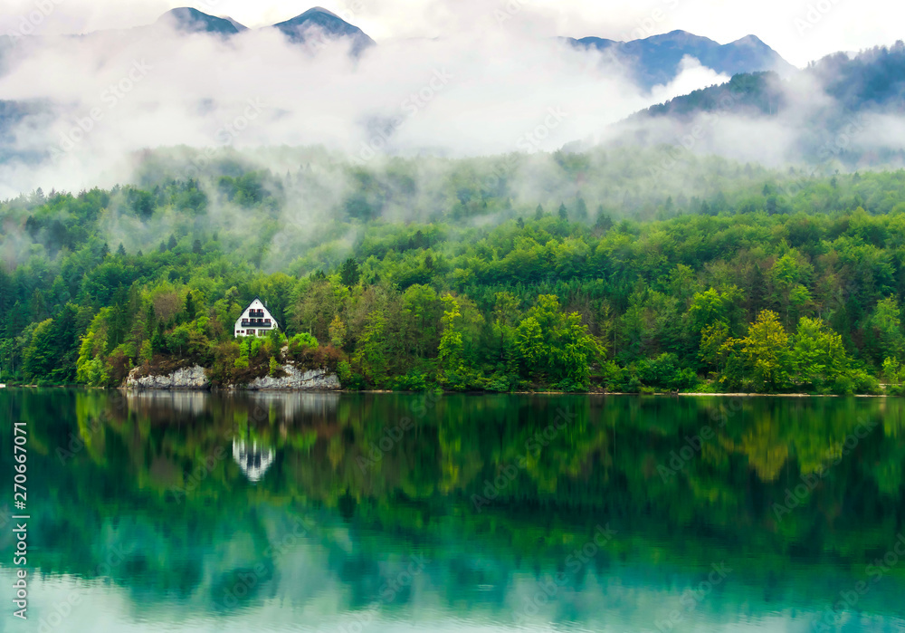 Holiday house by the lake Bohinj with reflections of the beautifull scenic landscape. Holiday house by the lake Bohinj with reflections of the beautifull scenic landscape.