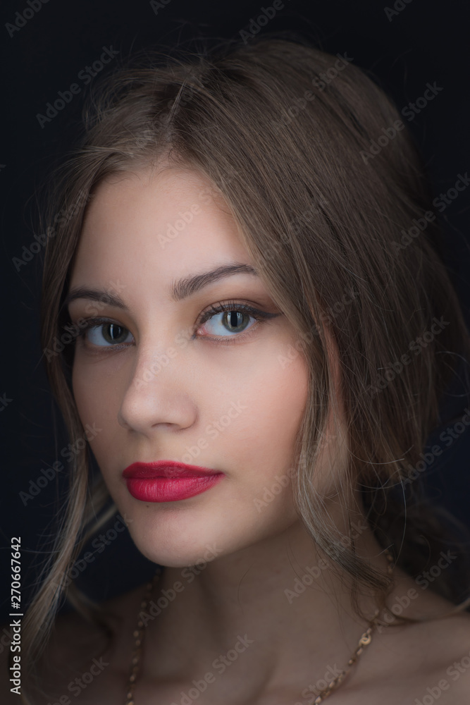 Beautiful ,young blonde with bright red lips and expressive eyes in a black jumpsuit. Beauty portrait of a girl. Emotional and bright appearance. Fashion portrait of a woman. Beautiful ,young blonde with bright red lips and expressive eyes in a black jumpsuit. Beauty portrait of a girl. Emotional and bright appearance. Fashion portrait of a woman.