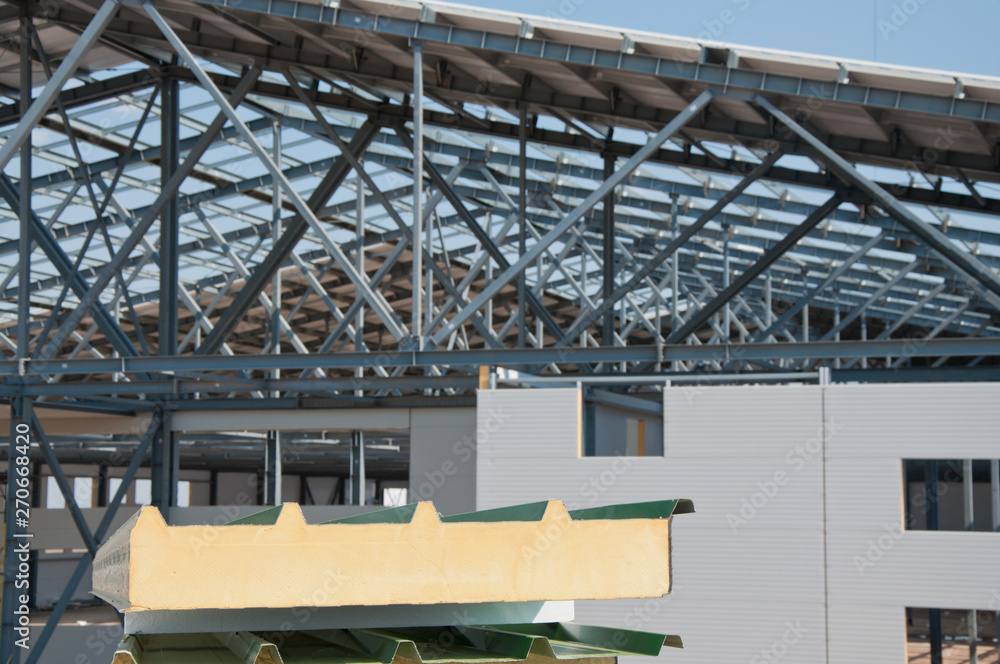 Fototapeta premium Sandwich panels at the construction site. Material for warming the walls of the building. Technologies in construction. An alternative to a brick building.